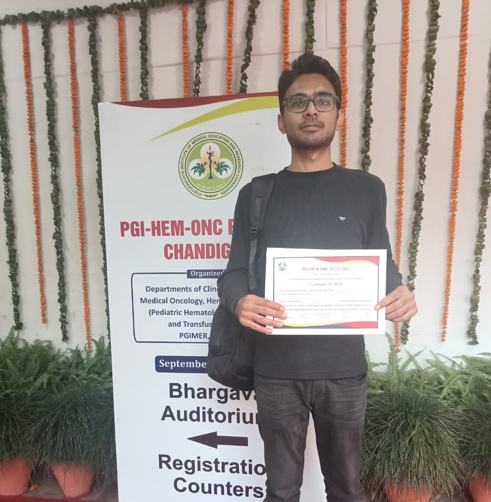 Ankit Patlan holding his poster competition certificate at PGI-HEM-ONC FEST 2023